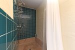 The shared bathroom has a large walk-in shower